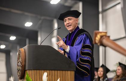 AU President Carlos Campo speaking at 2024 commencement